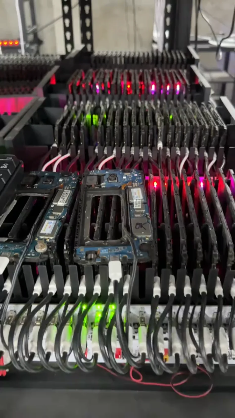 Rows of exposed mobile phone boards connected by cables in a device farm, shown with the same purple duotone treatment.