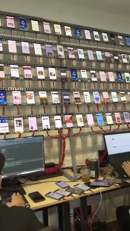 Rows of physical phones connected to computers, shown with a purple duotone treatment.